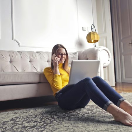 Woman researching insurance claim support on laptop from home